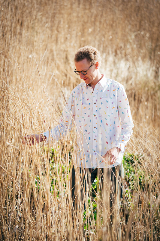 A man wearing colorful bird shirt