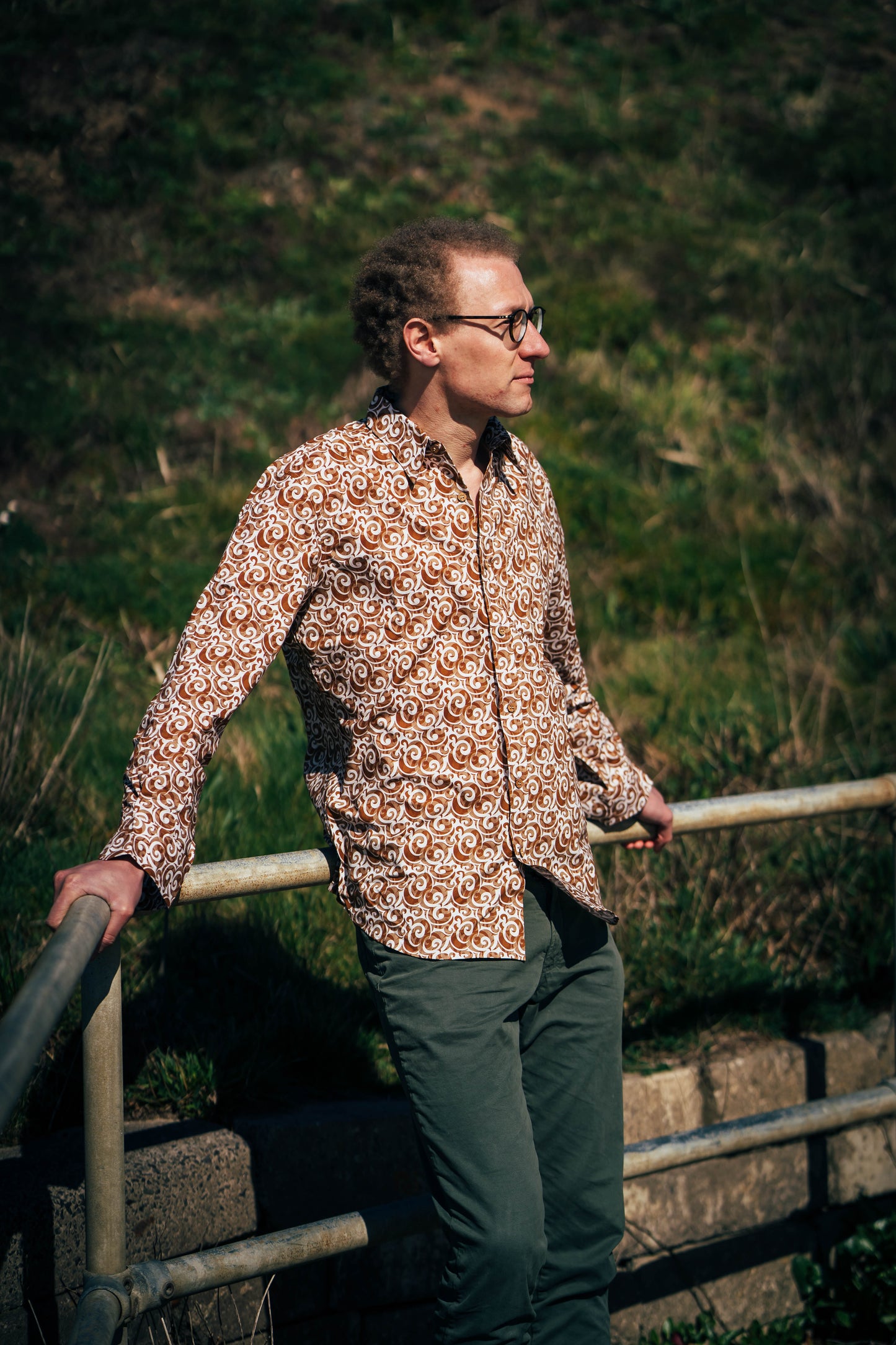 A man waring Golden-Brown Cotton Shirt with Swirling Motifs